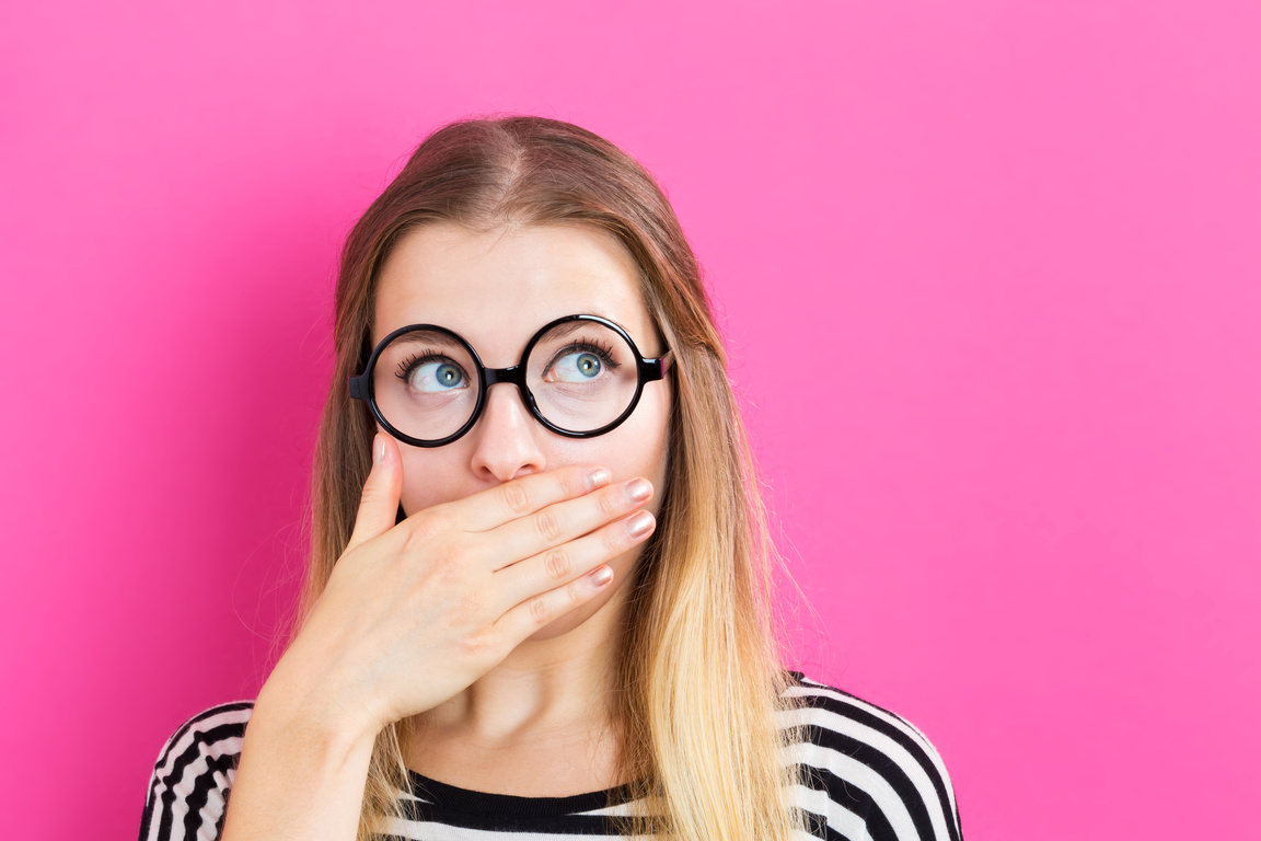 Young woman covering her mouth